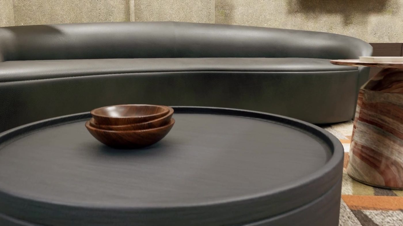 Table basse en bois sombre et coupelles en noyer sur un tapis Interface